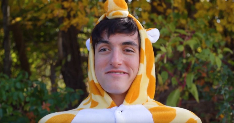 Still from someone found the giraffe guy!: a person in a giraffe costume grinning at the camera.